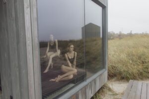 women wearing black swimsuit inside a sauna